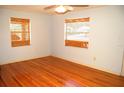 Empty bedroom with hardwood flooring and natural light at 255 S Pennsylvania Ave, Lake Alfred, FL 33850