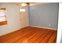 Bright living room featuring hardwood floors and a classic ceiling fan at 255 S Pennsylvania Ave, Lake Alfred, FL 33850