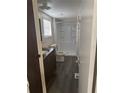 Bathroom with a walk-in shower, window, and vanity with wood cabinets at 2621 Island Oaks W, Lakeland, FL 33805