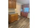 Functional kitchen with wood cabinets, laminate countertops, and neutral walls at 2621 Island Oaks W, Lakeland, FL 33805