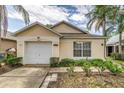 A quaint single-story home displaying a bright exterior, attached garage, and manicured landscaping at 2660 Hemingway Ave, Haines City, FL 33844
