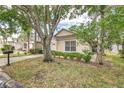 Inviting single-story home showcasing mature trees, manicured landscaping, and a cozy, well-kept front yard at 2660 Hemingway Ave, Haines City, FL 33844
