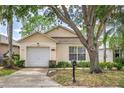 Charming single-story home with an attached garage, well-maintained lawn, and inviting curb appeal at 2660 Hemingway Ave, Haines City, FL 33844