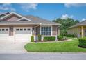 Well-maintained home exterior features a lush green lawn and beautiful landscaping at 2965 Mission Lakes Dr, Lakeland, FL 33803