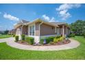 Exterior view of a home with a nicely landscaped yard and attractive curb appeal at 2965 Mission Lakes Dr, Lakeland, FL 33803