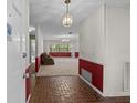 Inviting foyer with brick flooring that leads into a spacious living area with nice natural lighting at 3441 Sherertz Rd, Lakeland, FL 33810