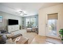 Inviting living room with a ceiling fan, plush seating, and decorative shelving with view of front door at 3560 Spring Creek Rd, Dundee, FL 33838