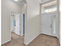 Bright foyer with tile flooring, high ceilings, and a view to an adjacent bathroom at 3592 Prescott Loop, Lakeland, FL 33810