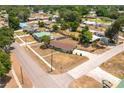 Aerial view of a neighborhood showcasing a single-story home with a brown roof at 400 6Th Ne St, Fort Meade, FL 33841