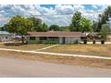 Charming single-story home with a green exterior, brown roof, and a front yard at 400 6Th Ne St, Fort Meade, FL 33841