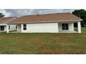 Side exterior shot of a single story new construction with a covered back porch and sliding glass door at 4056 Oak Loop # 100, Mulberry, FL 33860
