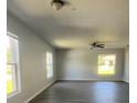 Bright and spacious living room featuring wood floors, a ceiling fan, and natural lighting at 4058 Oak Loop # 99, Mulberry, FL 33860