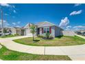 A gray single-Gathering home is presented with a green lawn and white fence at 4203 San Rocco Way, Winter Haven, FL 33884