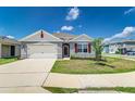Inviting single-Gathering home with a well-maintained lawn, two-car garage, and decorative shutters at 4203 San Rocco Way, Winter Haven, FL 33884