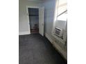 Unfurnished bedroom with window, dark carpet, and an open closet door at 4885 Cherry Dr, Mulberry, FL 33860