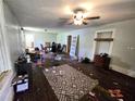Spacious living room with ceiling fan; renovation needed for updated look at 4885 Cherry Dr, Mulberry, FL 33860