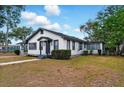 Cozy single-Gathering home featuring a well-maintained lawn and classic white and dark gray trim at 522 Channing Rd, Lakeland, FL 33805