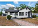 Attractive home with a brick pathway, lush lawn, and contrasting white and dark gray trim at 522 Channing Rd, Lakeland, FL 33805