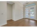 Bright entryway featuring hardwood floors, neutral paint and an abundance of natural light from front door at 5390 Clubhouse Hills Ln, Lakeland, FL 33812