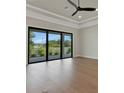 Open living room features wood-look floors and a large sliding glass door with backyard views at 5390 Clubhouse Hills Ln, Lakeland, FL 33812