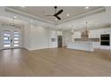 Open living space with white kitchen, hardwood floors and lots of natural light from entry door at 5390 Clubhouse Hills Ln, Lakeland, FL 33812