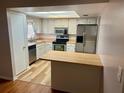 Functional kitchen features stainless steel appliances, wood countertops and a breakfast bar at 602 Avery Ln # 602, Lakeland, FL 33803