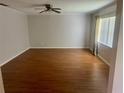 Spacious living room featuring hard wood floors, natural light, and a ceiling fan at 602 Avery Ln # 602, Lakeland, FL 33803