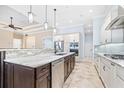 Modern kitchen featuring granite countertops, stainless steel appliances, and a functional island with a sink at 6347 Ashley Dr, Lakeland, FL 33813