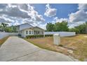 Charming house featuring a long driveway and a white fence, offering classic curb appeal at 640 Waldon N Ave, Bartow, FL 33830