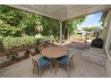 Enjoy this cozy covered outdoor patio area, complete with a table and seating, perfect for relaxing outdoors at 705 W Park St, Lakeland, FL 33803