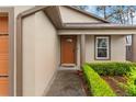 Close up exterior of front door with manicured shrubs at 7952 Grand Pines Blvd, Lakeland, FL 33810