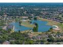 Aerial view of a residential community with a scenic lake and golf course at 800 Osprey Landing Dr, Lakeland, FL 33813