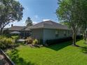 Beautifully landscaped backyard with a patio area, perfect for outdoor gatherings and enjoying the scenery at 800 Osprey Landing Dr, Lakeland, FL 33813