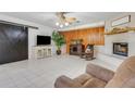Bright living room features painted brick fireplace, tile floors, wood accent wall, and barn door at 3822 Charter Rd, Lakeland, FL 33810