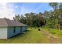 A spacious backyard with a lush green lawn and dense trees, providing ample privacy and shade at 10470 Sw 139Th Ct, Dunnellon, FL 34432