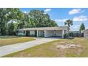 Well-maintained home featuring a covered carport, tidy landscaping, and a spacious driveway at 118 Lake Sears Dr, Winter Haven, FL 33880