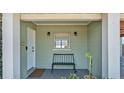Inviting covered porch with a bench, decorative lights, and a view of the lake at 118 Lake Sears Dr, Winter Haven, FL 33880