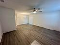 Spacious living room with modern ceiling fan, laminate flooring, and lots of natural light at 1251 Dosseywood Ln, Lakeland, FL 33811