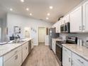 Modern kitchen with white cabinets, stainless steel appliances, and a large island at 1412 Portmore Dr, Mulberry, FL 33860