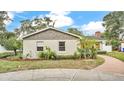 Exterior view of the home showcasing the garden and brick walkway to the front door at 1421 Camphor Dr, Lakeland, FL 33803
