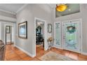 Elegant foyer with tile flooring, a decorative mirror, and access to the office and living areas at 146 Woodside Dr, Lakeland, FL 33813