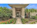 A welcoming entryway with decorative landscaping and a covered porch at 146 Woodside Dr, Lakeland, FL 33813