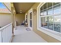Inviting front porch with seating area and decorative wreath, creating a warm entrance at 1519 Blue Sky Blvd, Haines City, FL 33844