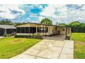 Inviting single-Gathering home featuring a well-manicured lawn and a spacious driveway, with ample parking at 1565 Heather Hill Dr, Lakeland, FL 33810