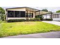Single-story home with a covered carport and well-maintained green lawn at 1565 Heather Hill Dr, Lakeland, FL 33810