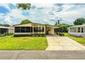 Attractive single-story home with a covered carport and lush green lawn at 1565 Heather Hill Dr, Lakeland, FL 33810