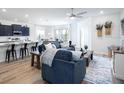Open concept living space featuring modern décor and an integrated kitchen with island seating at 1806 Teleford Rd, St Cloud, FL 34771