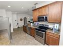 Well-equipped kitchen featuring stainless steel appliances, granite countertops, and ample cabinet space at 1825 Wallace Manor Ln, Winter Haven, FL 33880
