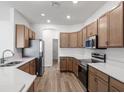 Modern kitchen featuring stainless appliances, light countertops and wood cabinets at 2033 Summerlake Dr, Auburndale, FL 33823