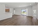 Bright living room featuring neutral walls, wood-look flooring and glass sliding doors to the backyard at 2033 Summerlake Dr, Auburndale, FL 33823